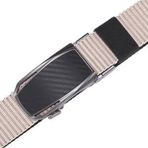 Detailed macro view of nylon tactical belt featuring carbon fiber texture metal buckle