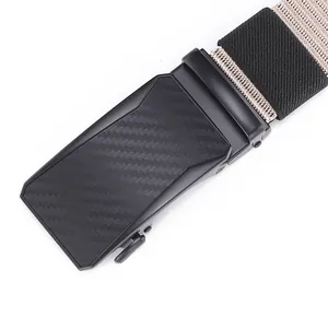 Detail of men's nylon tactical belt showing carbon fiber pattern on matte black buckle