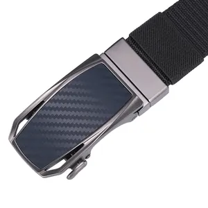 Detail of grey metal automatic buckle with carbon fiber texture on black nylon belt
