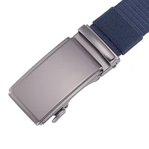 Detailed macro view of dark grey metal automatic buckle and navy woven canvas belt strap