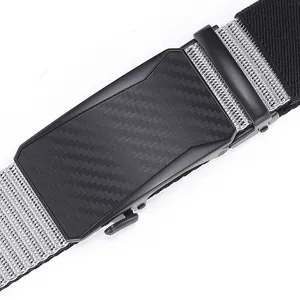 Detail of men's belt featuring black metal buckle with carbon fiber texture and grey woven strap