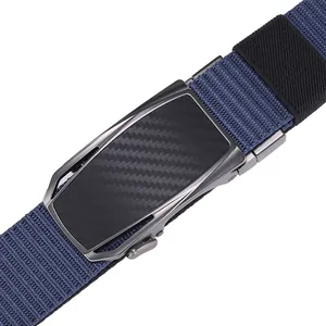 Close-up of navy blue nylon belt with grey metal automatic buckle and carbon fiber texture