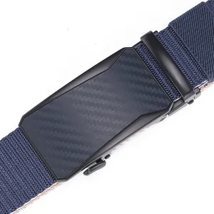 Detailed close-up of matte black automatic buckle with carbon fiber texture on blue belt