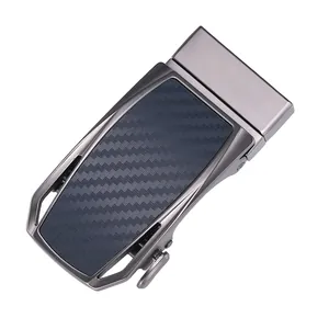 Detail of gunmetal alloy automatic belt buckle with carbon fiber texture inlay