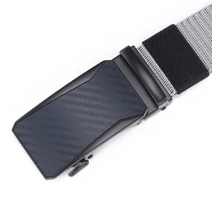 Macro detail of men's automatic belt buckle with carbon fiber texture and gray woven strap