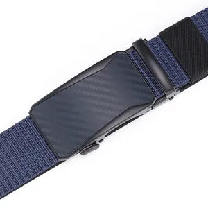 Detail of navy nylon belt with matte black metal buckle and carbon fiber texture inlay