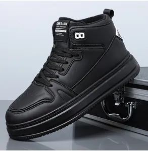 Detail view of black leather high-top sneakers with perforated toe and thick rubber soles