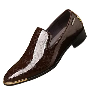Polished brown patent leather oxford shoes with intricate floral embossing and gold metallic toe