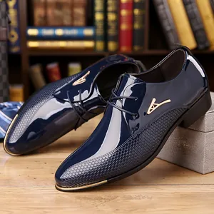 Detail of dark blue patent leather shoe with gold logo and honeycomb texture