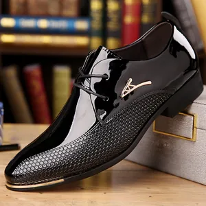 Close-up of black patent leather dress shoe with honeycomb texture and gold metal accents