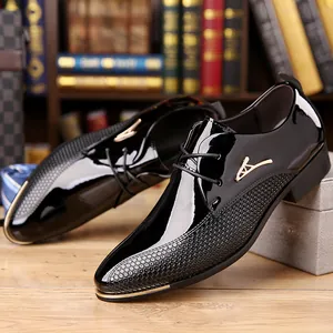 Macro detail of black patent leather dress shoe with gold buckle and grid texture