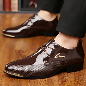 Detail of dark brown glossy leather dress shoe with gold metal trim and honeycomb texture