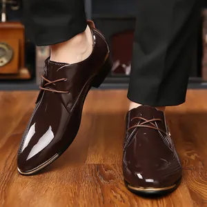 Detailed macro view of dark brown high-gloss patent leather shoes with metallic toe trim