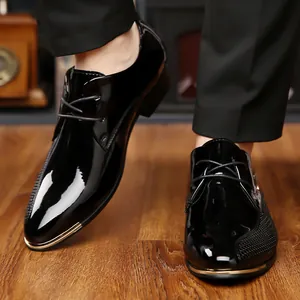 Close-up of polished black patent leather derby shoes showing mirror finish and fine laces