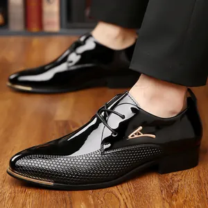 Detail of glossy black leather business shoes with honeycomb texture and gold metal accents