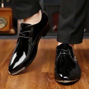Detail of glossy black patent leather shoe with woven texture and gold metal toe trim