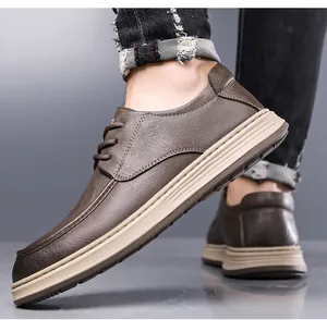 Close-up of brown leather casual loafers with non-slip thick soles worn with jeans