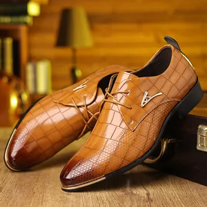 Detailed macro view of brown embossed crocodile leather and golden buckle on men's shoe