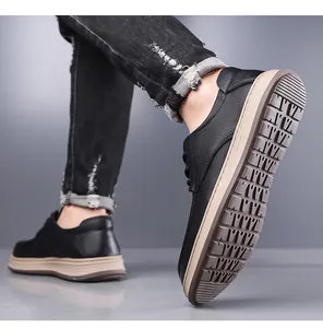 Detail view of men's black leather shoes with anti-slip rubber soles and litchi texture