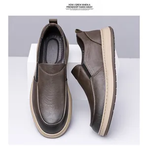 Detail of brown slip-on leather shoes with pebbled texture and thick beige anti-slip sole