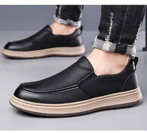 Close-up of men's black lychee leather slip-on loafers with durable beige rubber soles