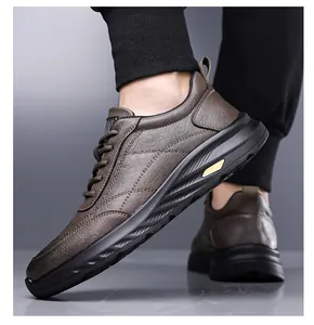 Macro side view of brown leather casual sneakers with thick black soles on feet