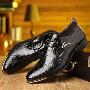 Detail of black crocodile texture leather shoe with gold logo and lace-up design