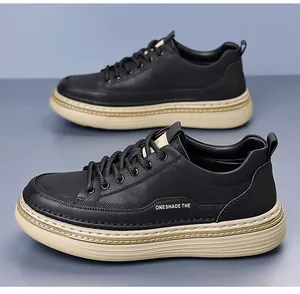 Detail view of black faux leather men's shoes with textured finish and thick beige sole