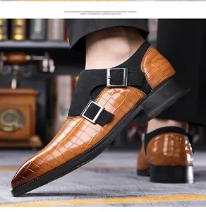 Detail of brown crocodile pattern monk strap leather shoe with dark gradient square toe