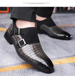 Detail of grey-black gradient monk shoes with crocodile texture and double buckles