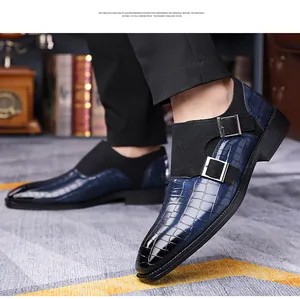 Close-up of blue crocodile pattern monk strap shoes with black suede details