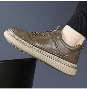 Detail view of brown leather casual shoe with yellow stitching and thick rubber sole