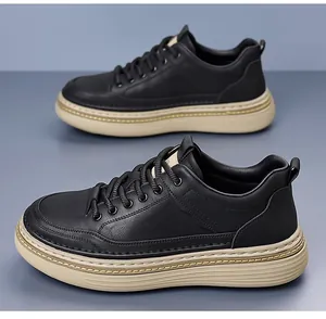 Detail view of black leather casual shoes with thick beige rubber soles and stitching