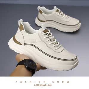 Close-up of beige chunky sneakers with sport lettering and durable leather texture