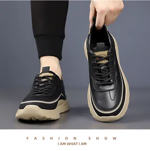 Detail showing the chunky beige midsole and black leather texture of men's casual sneakers