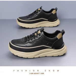 Detail of black synthetic leather chunky sneakers with SPORT embossing and thick rubber soles
