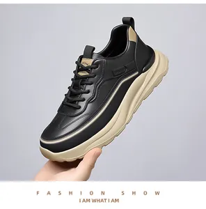 Detailed close-up of men's chunky sneakers with black and beige leather paneling and sport logo