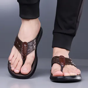 Men's dark brown crocodile embossed leather flip flops with a black non-slip sole
