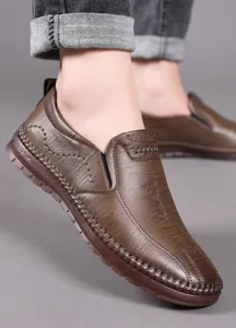 Detail of brown leather loafers with pebble grain texture and durable rubber sole