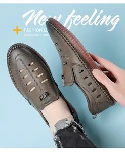 Detail view of brown men's leather sandals showing breathable cutouts and hand-stitched seams