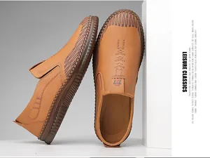 Detail view of brown men's slip-on leather shoes with decorative stitching and textured toe