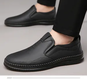 Detail view of men's black slip-on loafers with textured leather and non-slip rubber sole