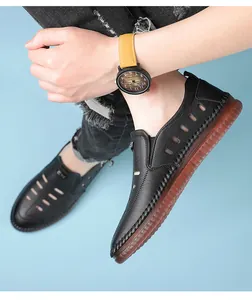 Detail view of men's black hollow leather sandals with anti-slip rubber soles for summer