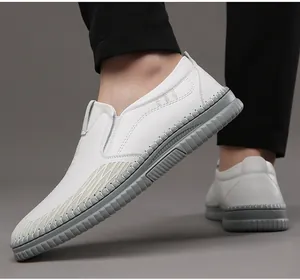 Close-up of white leather slip-on loafers with durable non-slip gray rubber soles