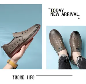 Detailed macro view of men's brown hollow leather loafers with breathable hole design