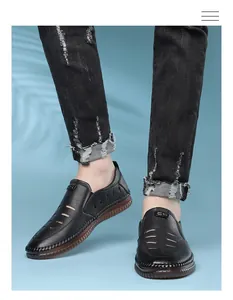 Detail of men's black leather sandals with hollow out design and anti-slip rubber sole