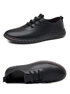 Macro shot of black men's leather slip-on shoe with non-slip rubber sole and stitching