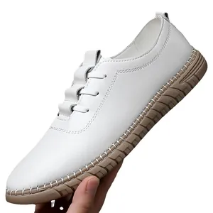 White leather men's slip-on casual loafers with brown rubber sole and stitched details