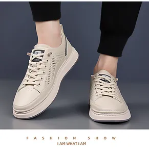 Detail shot of men's beige sneakers with breathable perforations and a thick sole