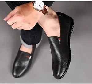 Detail shot of black leather loafers for men with red-white-blue ribbon accent